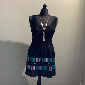 Black dress , jean jacket and necklace .